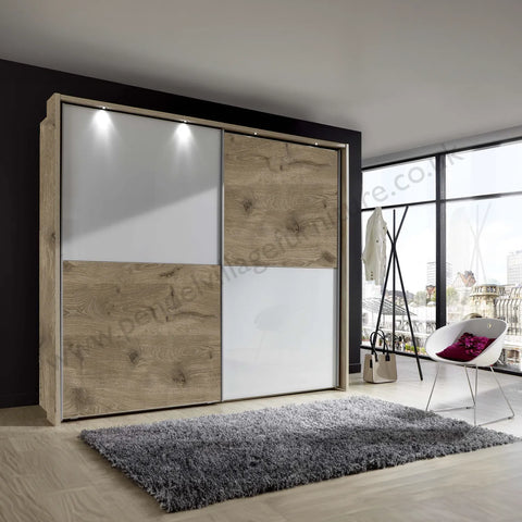 Wiemann Bristol Nordic Oak and White Sliding Door Wardrobe With Mirror, We will Deliver and assemble the wardrobe. Available in 4 Width Sizes 150cm, 200cm, 250cm and 300cm height is 217cm - Lifestyle Image