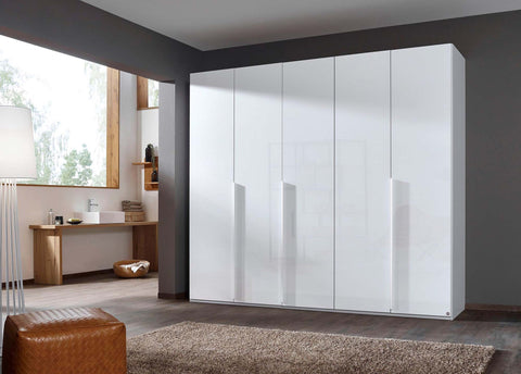 Frans Large 5 Door Wardrobe by Rauch with color glass fronts. Choose from refined White, Silk Grey, or Graphite finishes. Chic and versatile storage solution for your bedroom, featuring sophisticated design elements, comes with free assembly service. - Lifestyle