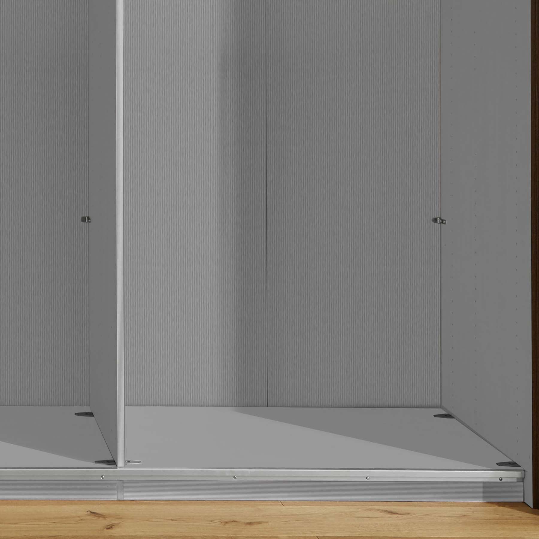 Monroe Triple Wardrobe showcasing elegant sliding doors, chrome handles, and a choice of Bianco Oak, White, Pebble Grey, or Champagne finishes. Interior includes shelves and hanging rails. Experience premium quality with free delivery, professional assembly, and pay monthly options, Brand Wiemann. - Interior Detail 4