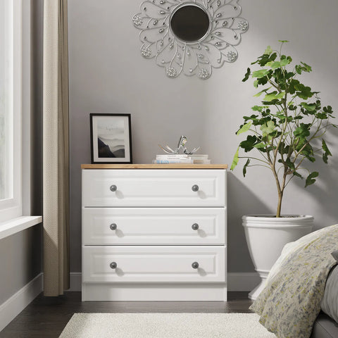 Norfolk 3 Drawer Chest, Norfolk is a two colour tone Bedroom Furniture which has Bardilon oak top and painted base. Available in choice of 3 colours White, Kashmir and Grey. Fully Assembled. Quick Delivery - Lifetsyle Image