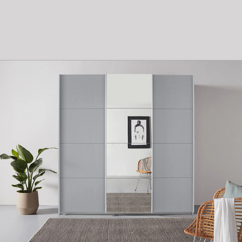 Rauch Forms 3 Door Sliding Wardrobe in Silk Grey with Middle Mirror door and Matching Door Handles. Available in Small (203cm) and Large (271cm) widths, with options for 210cm or 229cm height. Designed for bedroom storage with customisable interior Pendle Village Furniture Wardrobes - Lifestyle Image