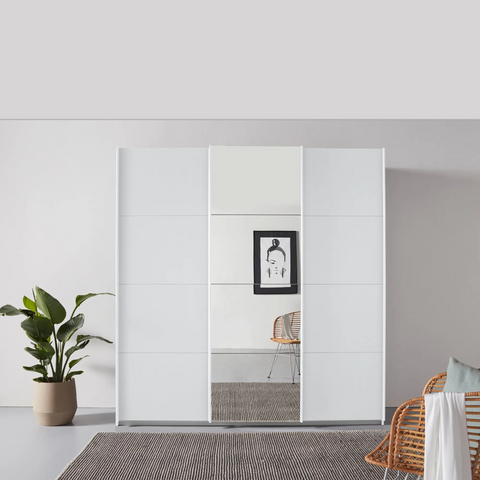 Rauch Forms 3 Door Sliding Wardrobe in Alpine White with Middle Mirror door and White Handles. Available in Small (203cm) and Large (271cm) widths, with options for 210cm or 229cm height. Designed for bedroom storage with customisable interior Pendle Village Furniture Wardrobes - Lifestyle Image