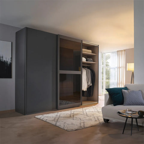 Lumis 3 Door Sliding Wardrobe, A spacious and stylish 3-door sliding wardrobe in graphite finish, perfect for modern bedrooms. Dimensions: Width 300cm, Height 223cm, Depth 68cm. Free delivery and assembly included. The middle door is equipped with transparent glass for added elegance. - Lifestyle Image