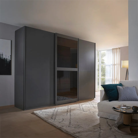 Lumis 3 Door Sliding Wardrobe, A spacious and stylish 3-door sliding wardrobe in graphite finish, perfect for modern bedrooms. Dimensions: Width 300cm, Height 223cm, Depth 68cm. Free delivery and assembly included. The middle door is equipped with transparent glass for added elegance. - Lifestyle Image 2