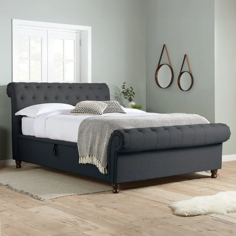 Venice Ottoman Bed: A chic statement piece with buttoned detailing, rolled headboard, and Ottoman storage. Elevate your bedroom with unbeatable comfort and style during this limited-time sale. Available in Double, Small Double, and King sizes - Charcoal Lifestyle  Image