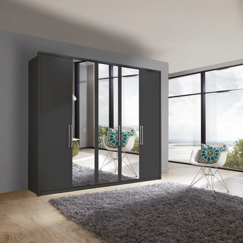 Image of Wiemann Bristol 5 Door Wardrobe with Graphite Carcase. Option of Matt or Glass finish on side doors, with middle doors featuring mirror pads. Dimensions: Width 250cm, Height 216cm, Depth 58cm. Free Delivery and Assembly. 12 months interest-free pay monthly available. - Lifestyle Image