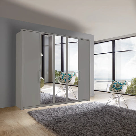 Image of Wiemann Bristol Pebble Grey 5 Door Wardrobe with Mirror. Option of Matt or Glass finish on side doors, with middle doors featuring mirror pads. Dimensions: Width 250cm, Height 216cm, Depth 58cm. Free Delivery and Assembly. 12 months interest-free pay monthly available. - Lifestyle Image